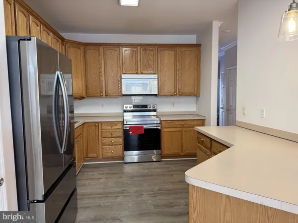 a kitchen with a refrigerator sink and stove