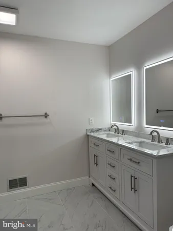 a bathroom with a double vanity sink and mirror