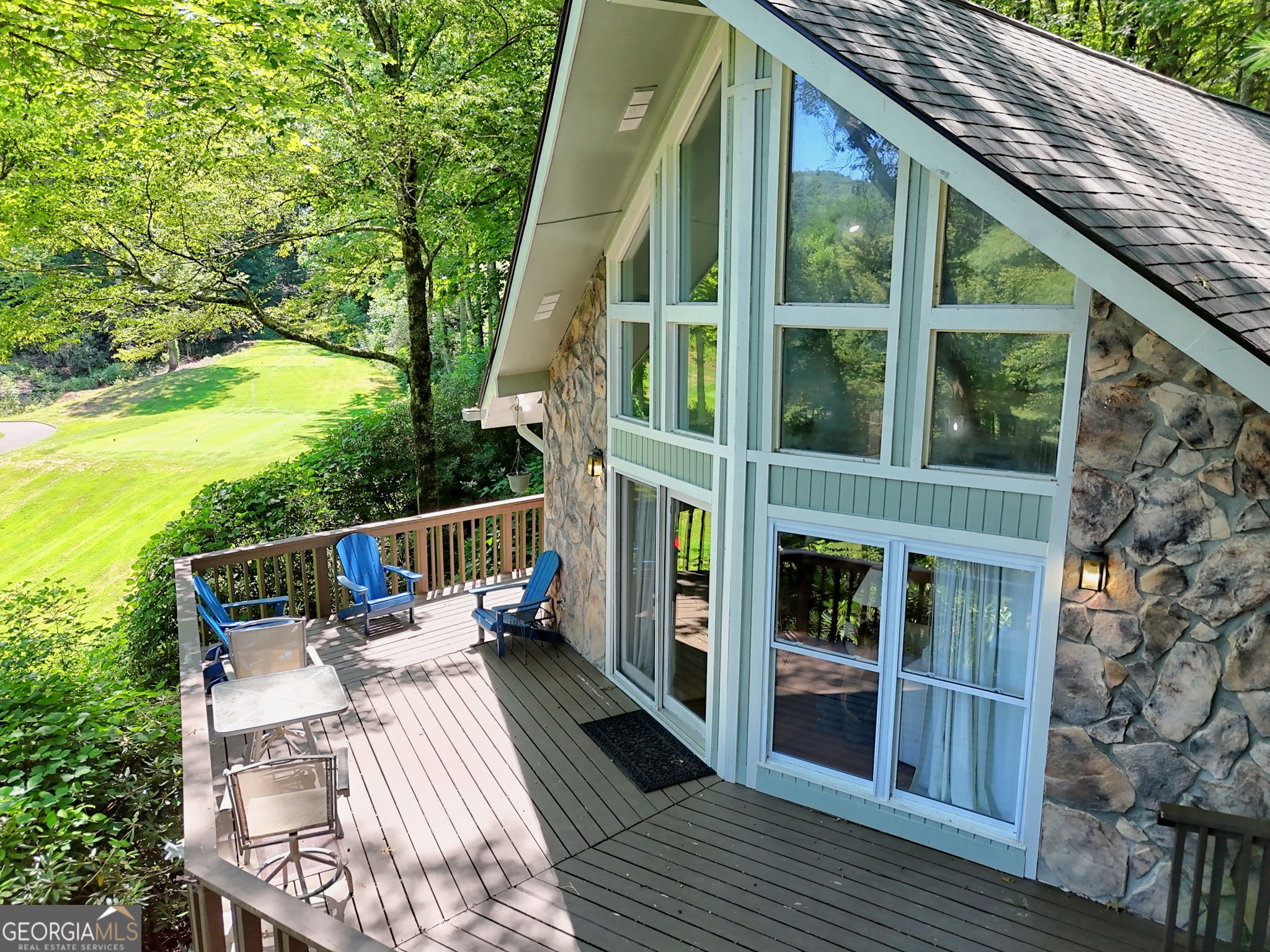 850 Ridgepole Drive Sky Valley, GA 30537 - Photo 1 of 73 a balcony with wooden floor and outdoor seating
