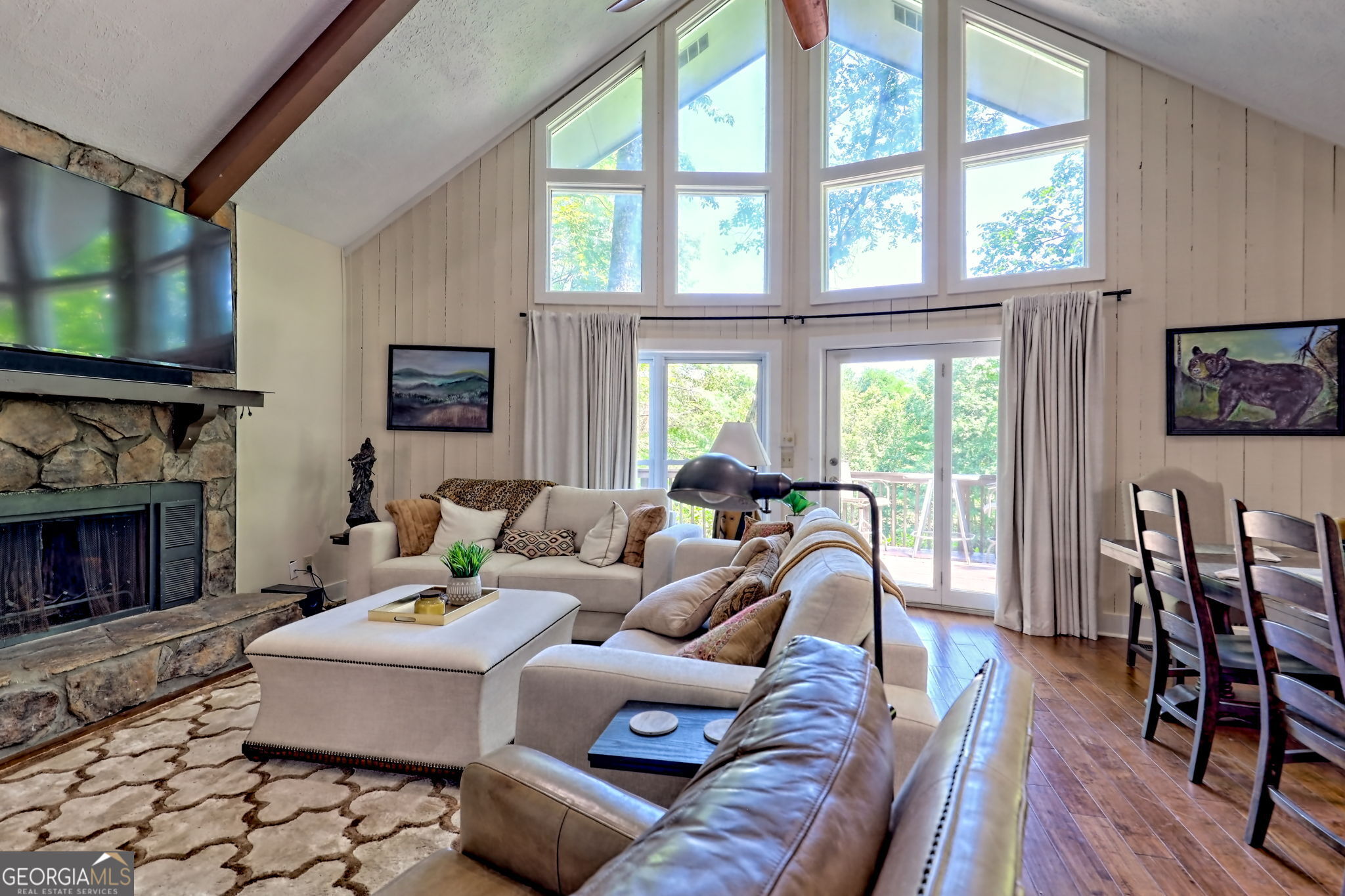 850 Ridgepole Drive Sky Valley, GA 30537 - Photo 16 of 73 a living room with furniture a flat screen tv and a fireplace