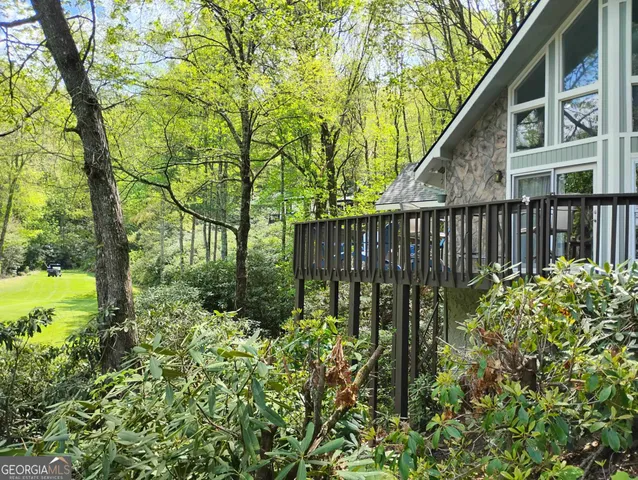 a view of a house with pool and sitting area