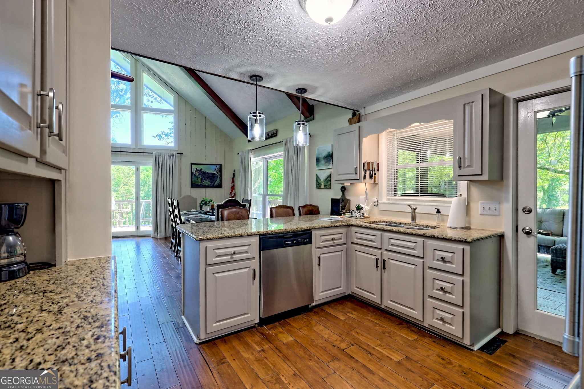 850 Ridgepole Drive Sky Valley, GA 30537 - Photo 21 of 73 a kitchen with a sink cabinets wooden floor and stainless steel appliances