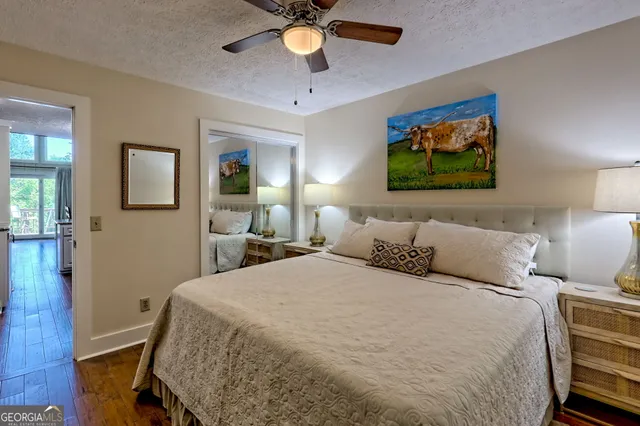 a living room with furniture a flat screen tv and a floor to ceiling window