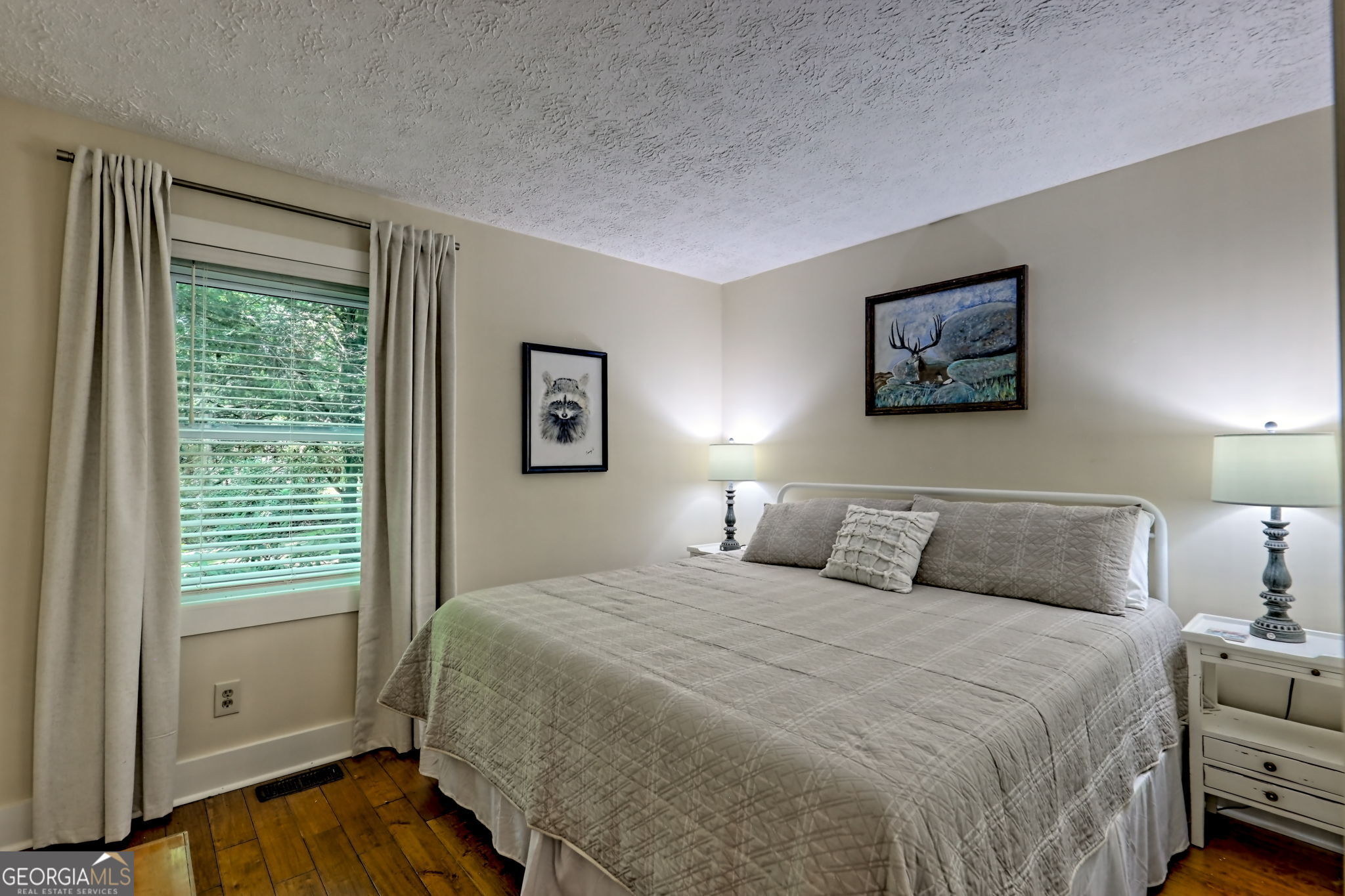 850 Ridgepole Drive Sky Valley, GA 30537 - Photo 35 of 73 a bedroom with a bed and a painting on the wall