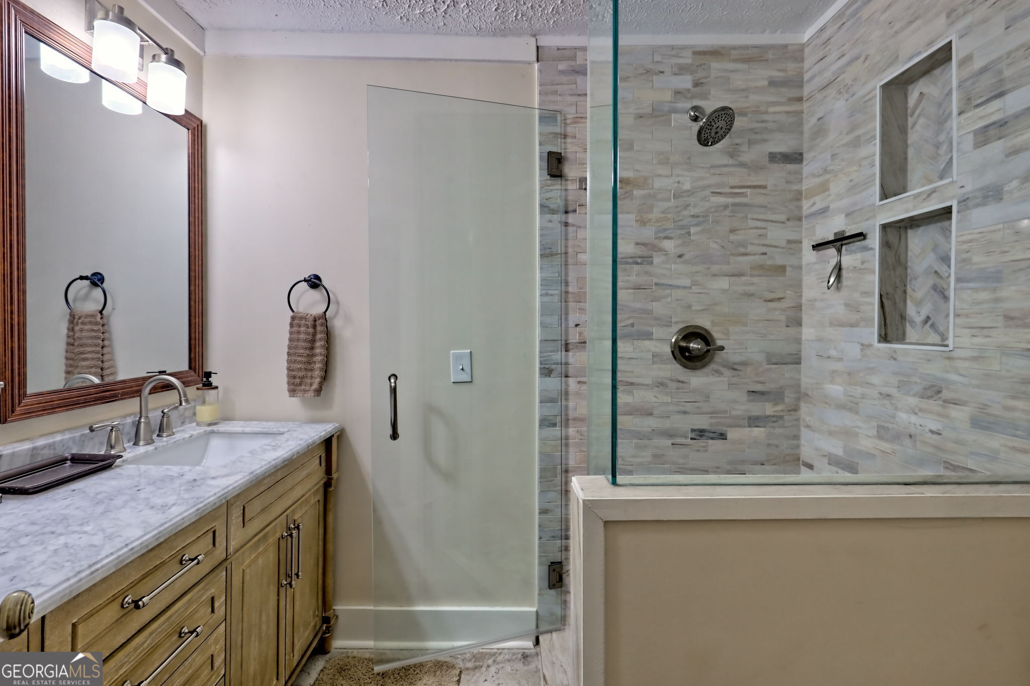 850 Ridgepole Drive Sky Valley, GA 30537 - Photo 38 of 73 a bathroom with a granite countertop sink a mirror and shower