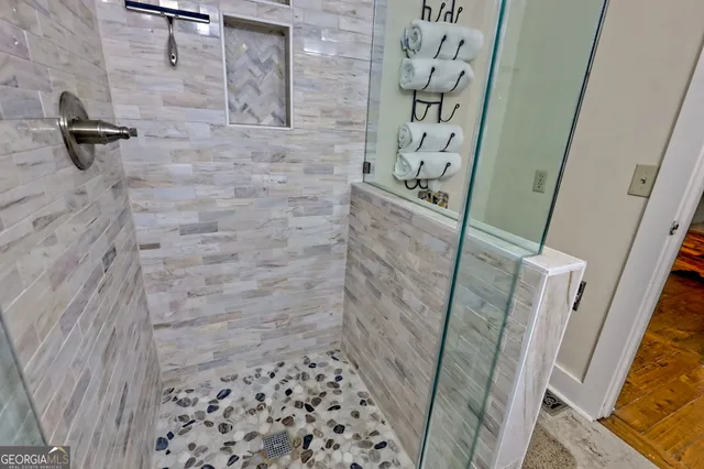 a balcony of a house with wooden floor and outdoor seating