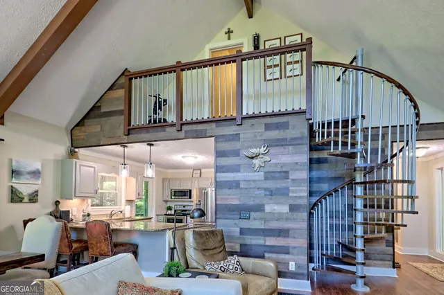 a view of a yard with plants and large trees