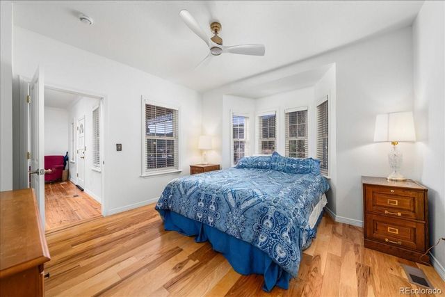 a bedroom with a bed and wooden floor