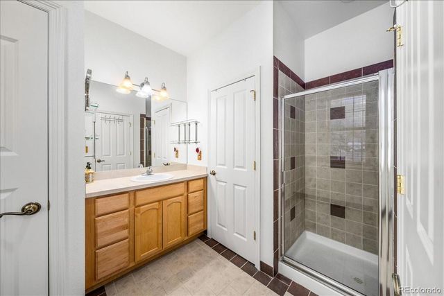 a bathroom with a shower sink and mirror