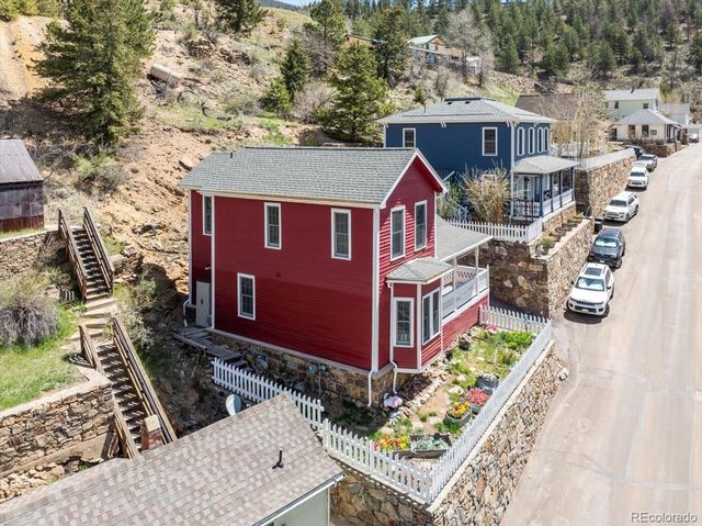 an aerial view of a house with a yard