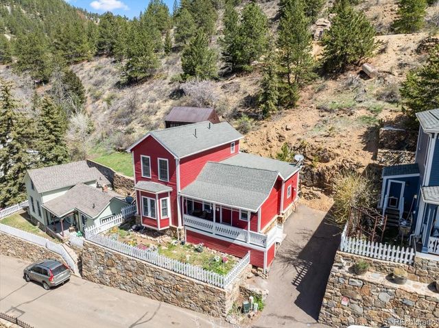 an aerial view of a house with a yard