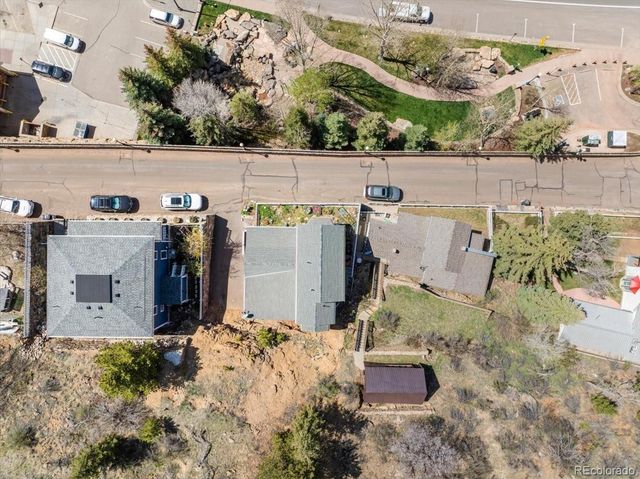 an aerial view of a house with a yard