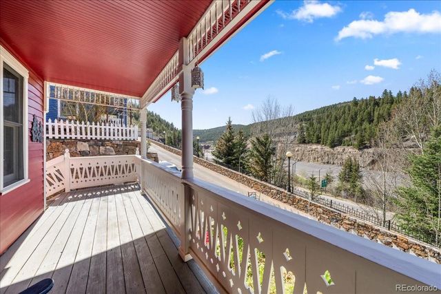 a view of balcony with a large window and wooden floor