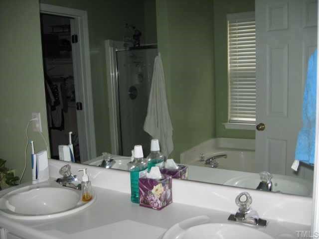 3925 Hopper Street Raleigh, NC 27616 - Photo 7 of 12 master bath with two sinks, tub and separate shower