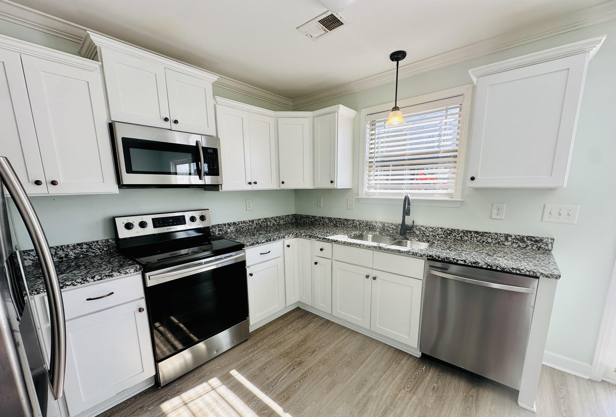 935 Bluebird Road Lebanon, TN 37087 - Photo 5 of 11 a kitchen with granite countertop cabinets stainless steel appliances and a sink
