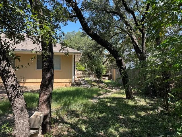 a view of house with backyard