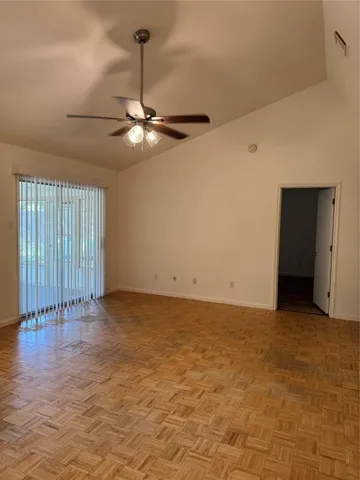 a view of an empty room with a ceiling fan