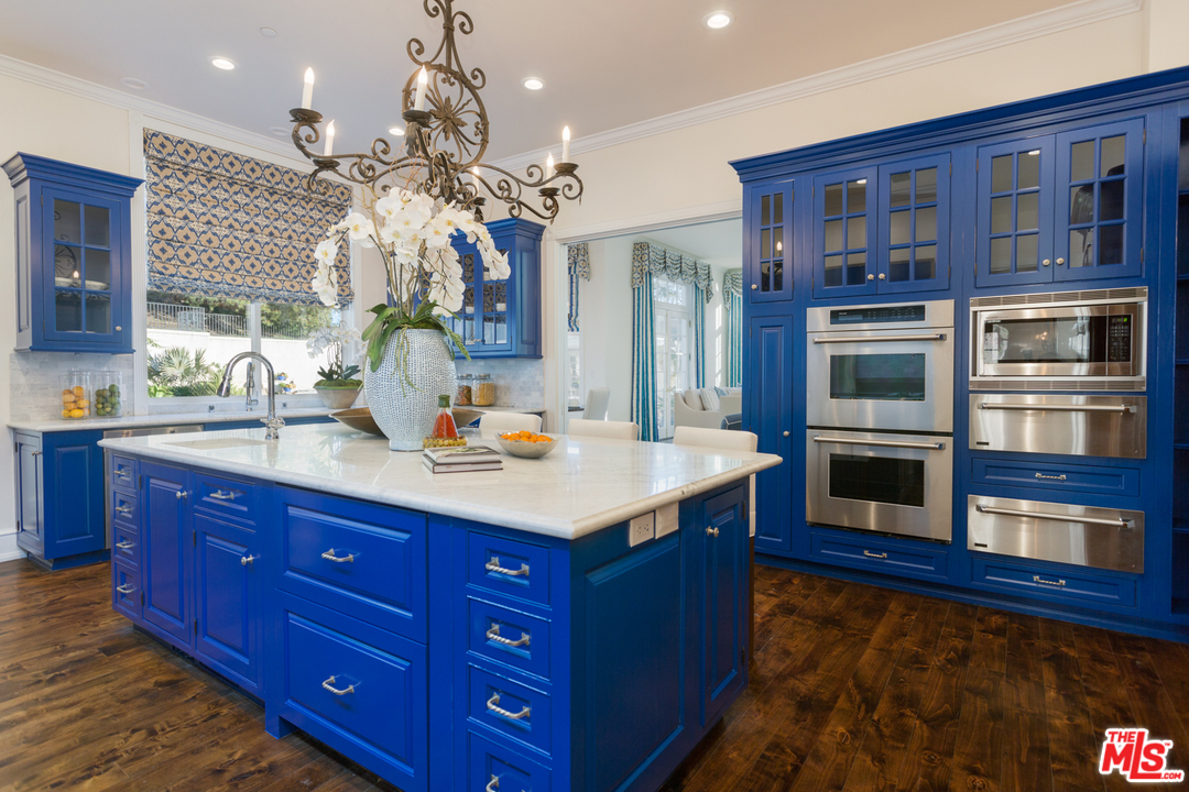 65 Beverly Park Beverly Hills, CA 90210 - Photo 19 of 51 a kitchen with stainless steel appliances granite countertop a kitchen island a stove and a sink
