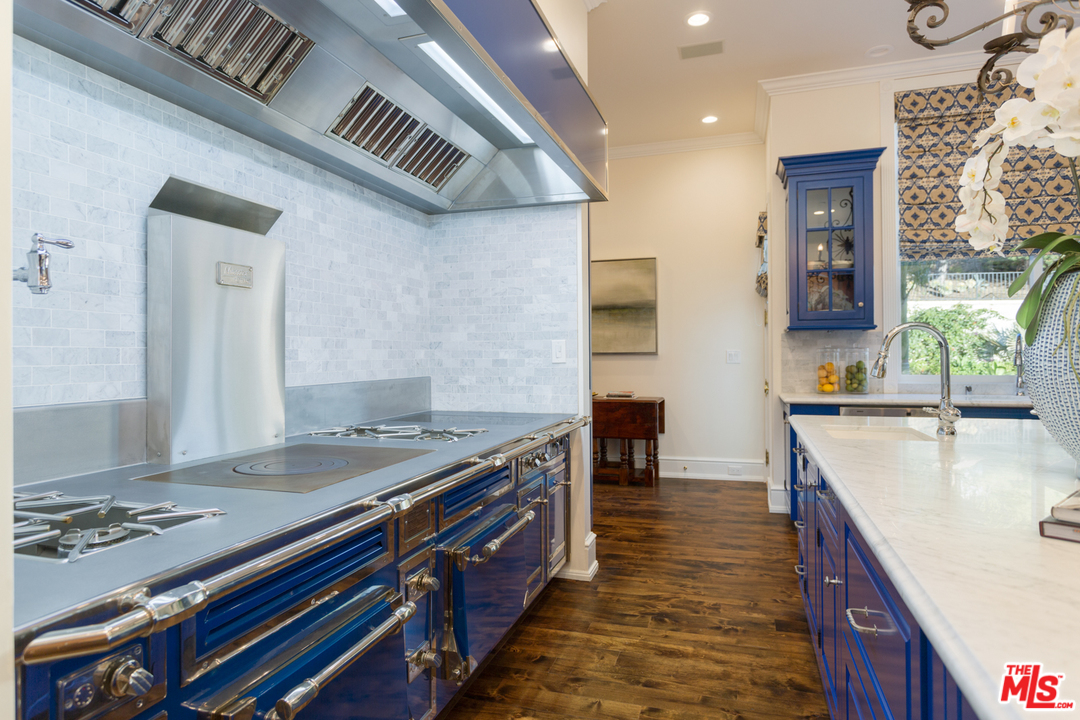 65 Beverly Park Beverly Hills, CA 90210 - Photo 21 of 51 a kitchen with stainless steel appliances granite countertop a sink stove and cabinets