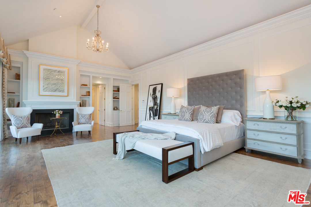65 Beverly Park Beverly Hills, CA 90210 - Photo 24 of 51 a spacious bedroom with a bed and a chandelier