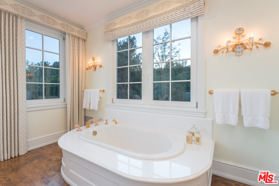 65 Beverly Park Beverly Hills, CA 90210 - Photo 29 of 51 a white bath tub sitting next to a window