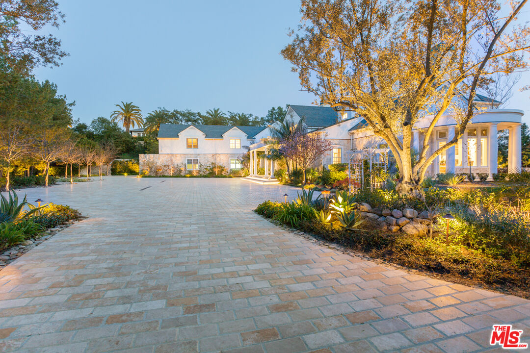 65 Beverly Park Beverly Hills, CA 90210 - Photo 4 of 51 a view of a yard with cars parked in front of it