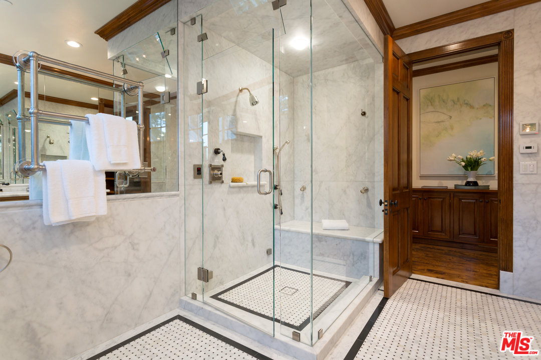 65 Beverly Park Beverly Hills, CA 90210 - Photo 32 of 51 a bathroom with a glass shower door