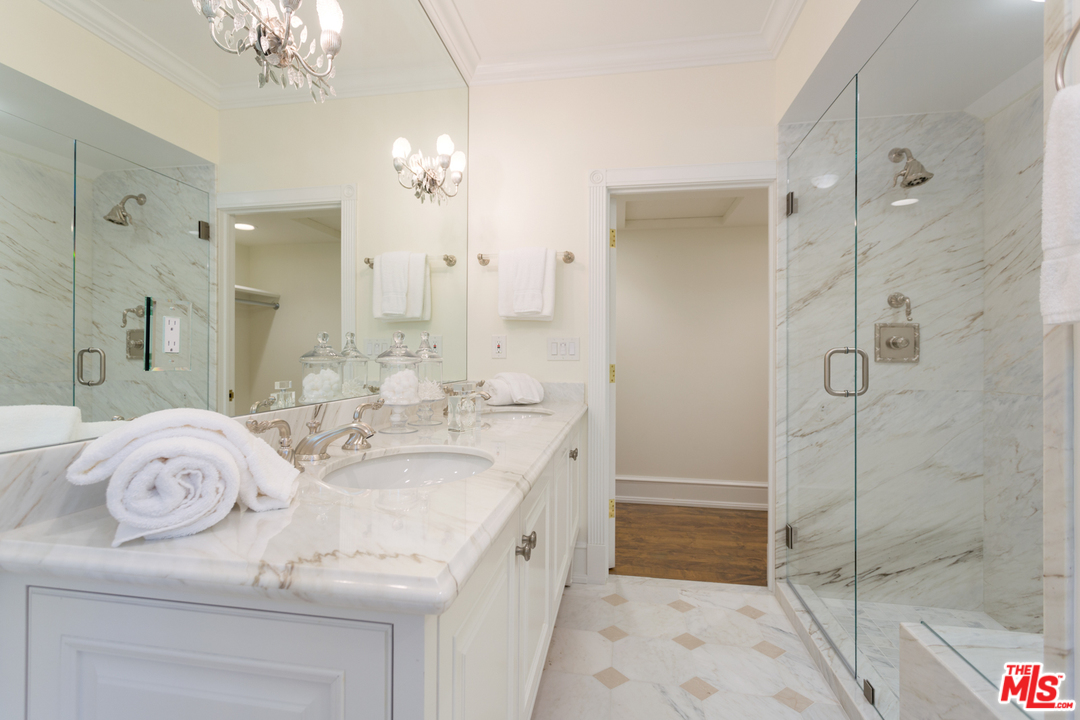 65 Beverly Park Beverly Hills, CA 90210 - Photo 36 of 51 a spacious bathroom with a granite countertop sink a mirror and shower
