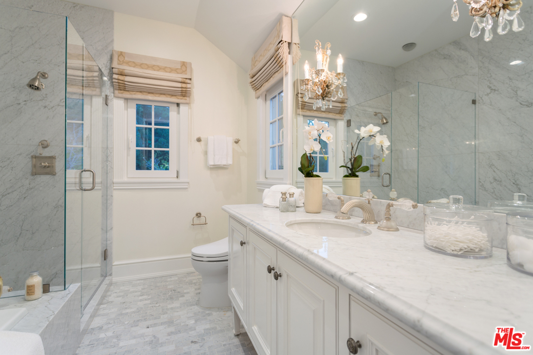 65 Beverly Park Beverly Hills, CA 90210 - Photo 42 of 51 a bathroom with a granite countertop sink a toilet and shower