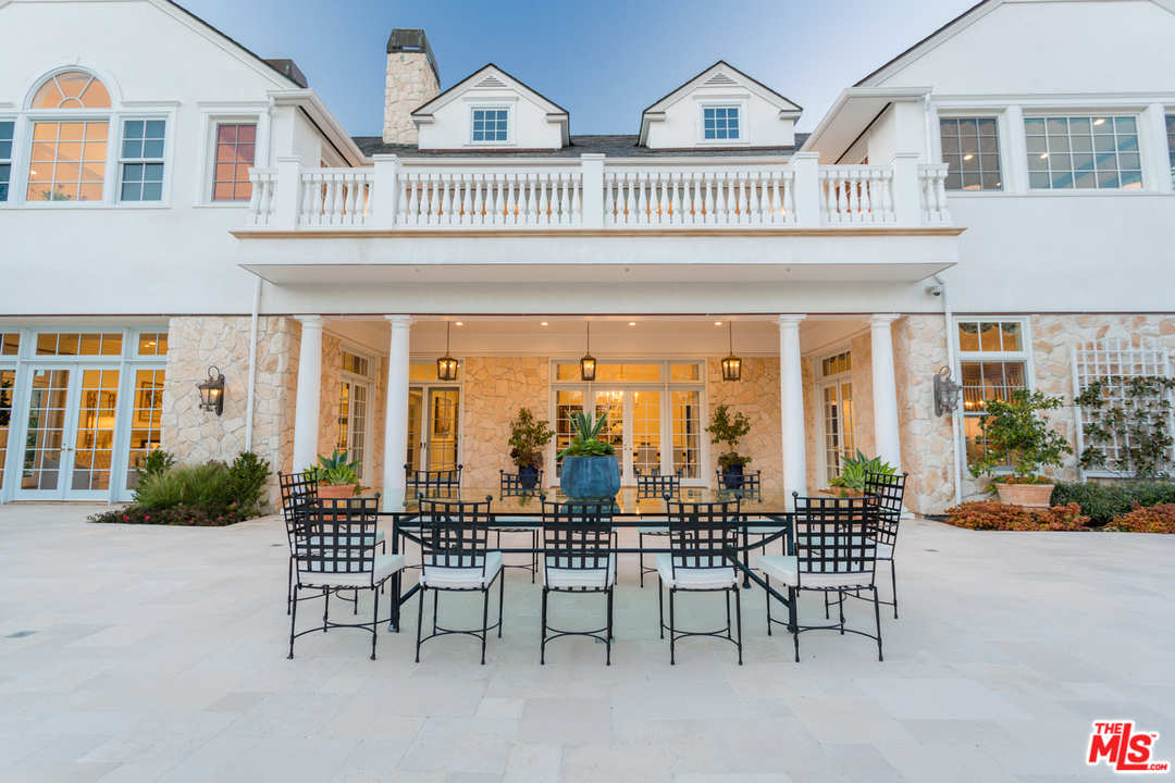 65 Beverly Park Beverly Hills, CA 90210 - Photo 45 of 51 a view of a patio with couches table and chairs and potted plants