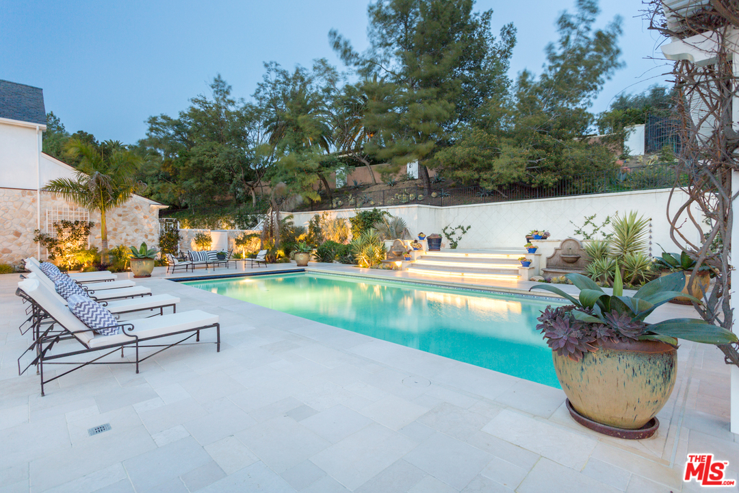 65 Beverly Park Beverly Hills, CA 90210 - Photo 49 of 51 a view of a swimming pool with outdoor seating and plants