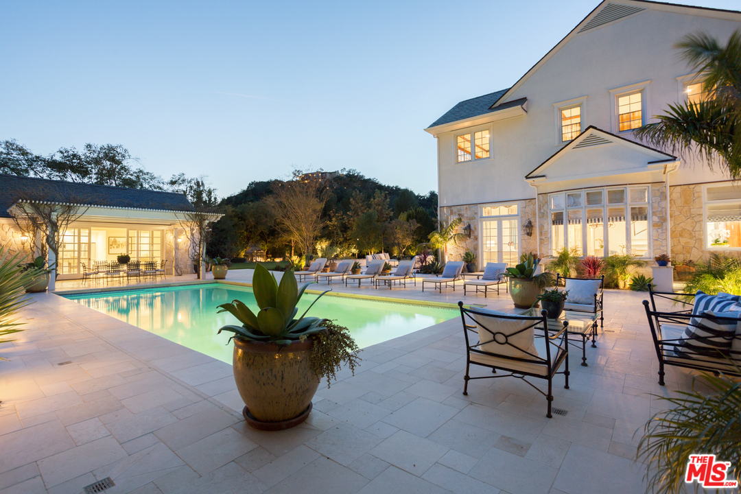 65 Beverly Park Beverly Hills, CA 90210 - Photo 51 of 51 a view of a patio with dining table and chairs potted plants