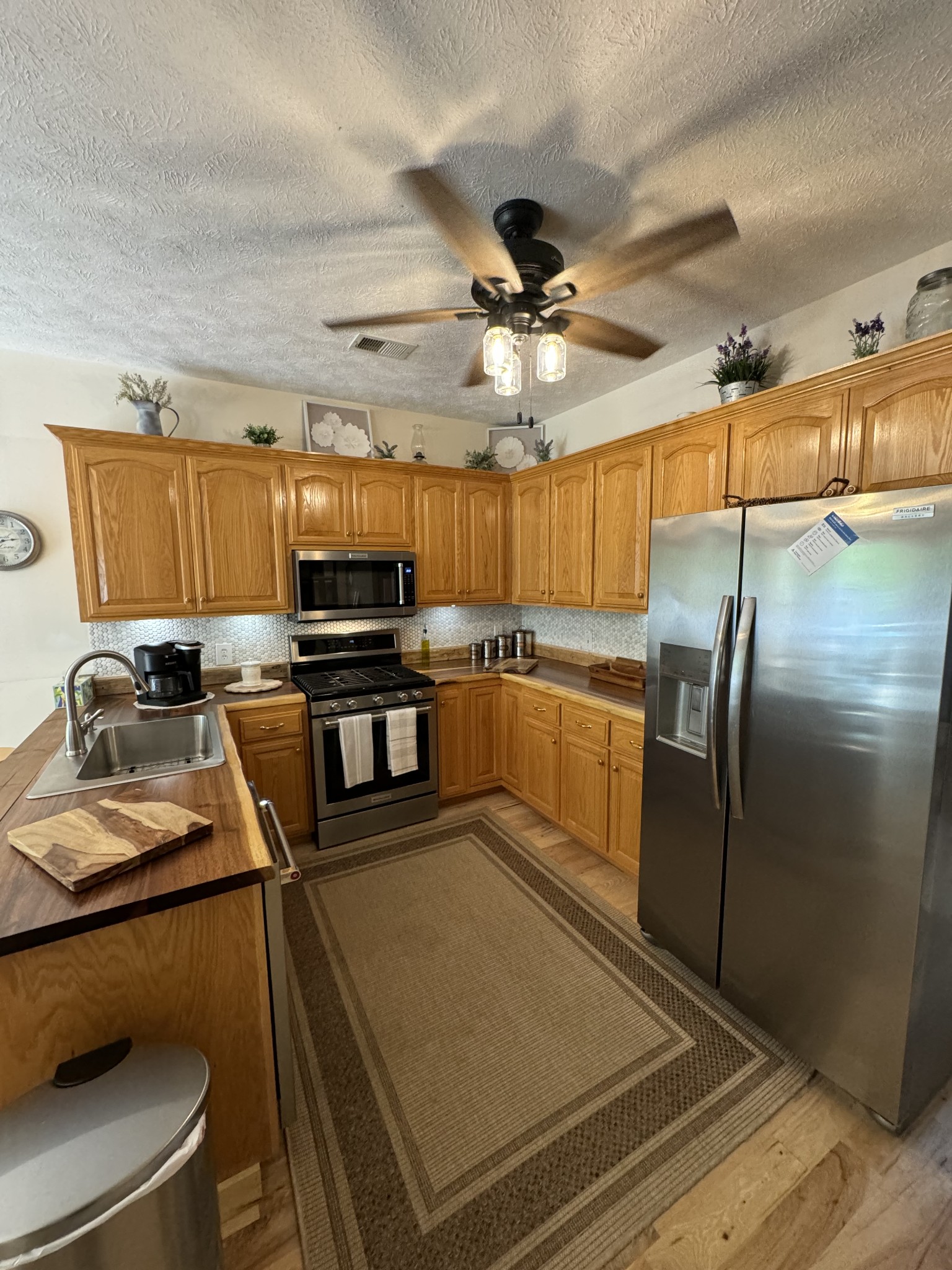 284 Baker Road Dickson, TN 37055 - Photo 24 of 36 a kitchen with stainless steel appliances granite countertop a sink refrigerator and cabinets