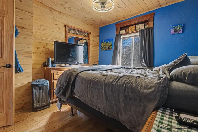 a bedroom with a bed and a flat screen tv