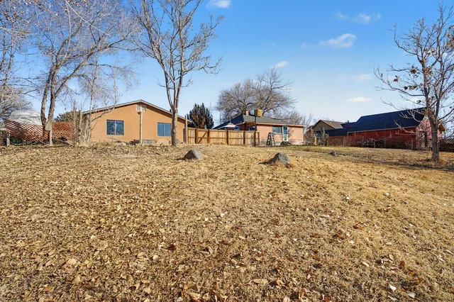 a white house that has a tree in front of it