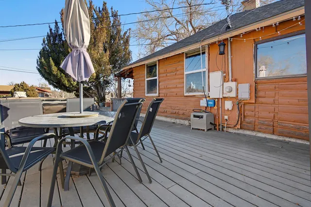 a view of a patio with table and chairs and wooden floor
