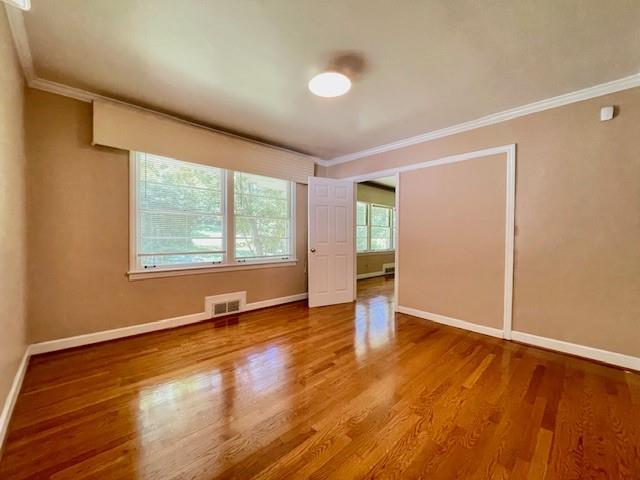 2396 Lavista Road Northeast Atlanta, GA 30329 - Photo 4 of 28 an empty room with wooden floor and windows