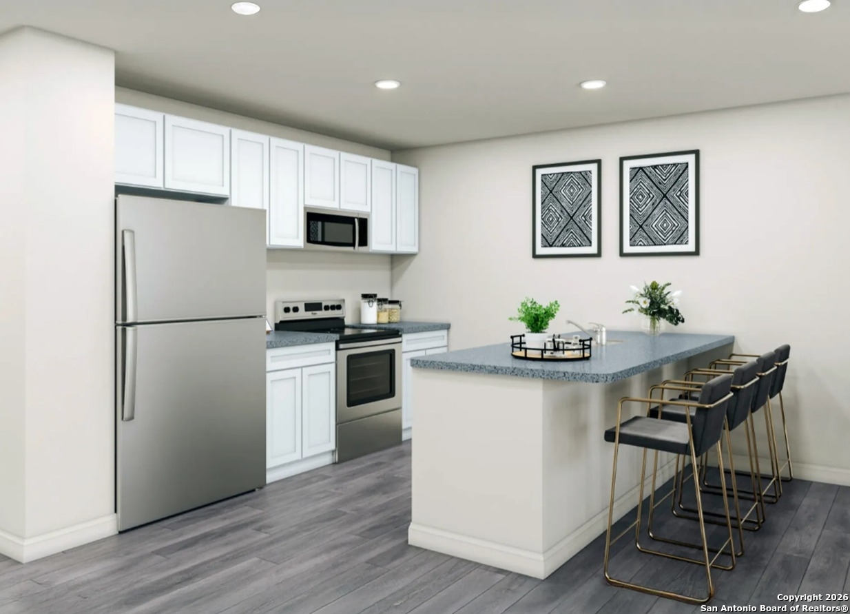 133 Sutton Place Uvalde, TX 78801 - Photo 4 of 4 a kitchen with stainless steel appliances a refrigerator a stove a sink and a refrigerator