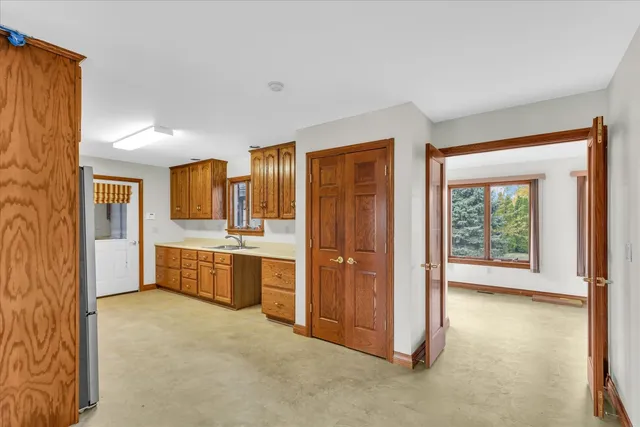 a large bathroom with a large mirror vanity and shower