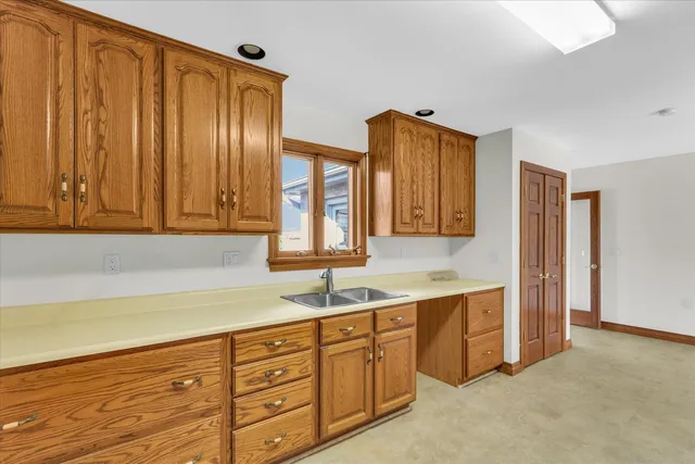 a kitchen with stainless steel appliances granite countertop a refrigerator stove and sink with cabinets
