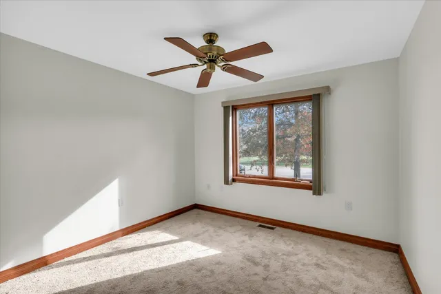 a view of room with a ceiling fan
