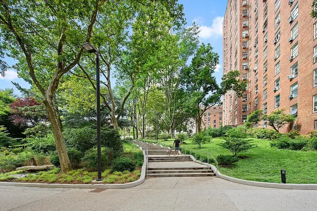 a walkway with trees in front of it