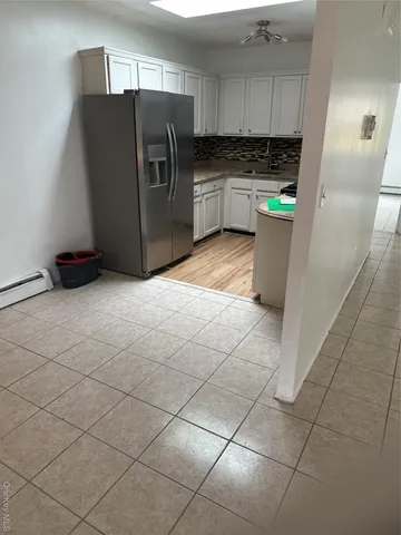 a kitchen with stainless steel appliances a refrigerator sink and cabinets