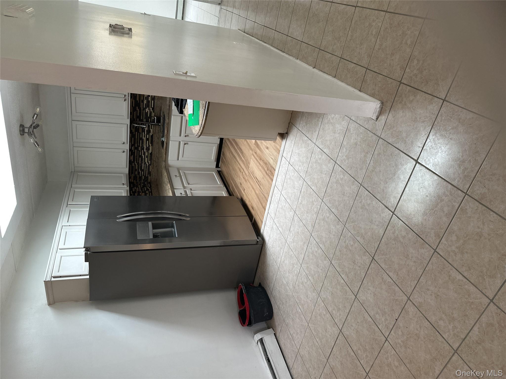 43 Menahan Street, Unit 2 Brooklyn, NY 11221 - Photo 3 of 5 a kitchen with stainless steel appliances a refrigerator sink and cabinets