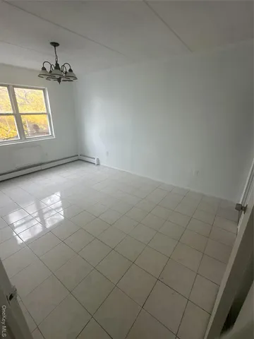 a view of an empty room and a window