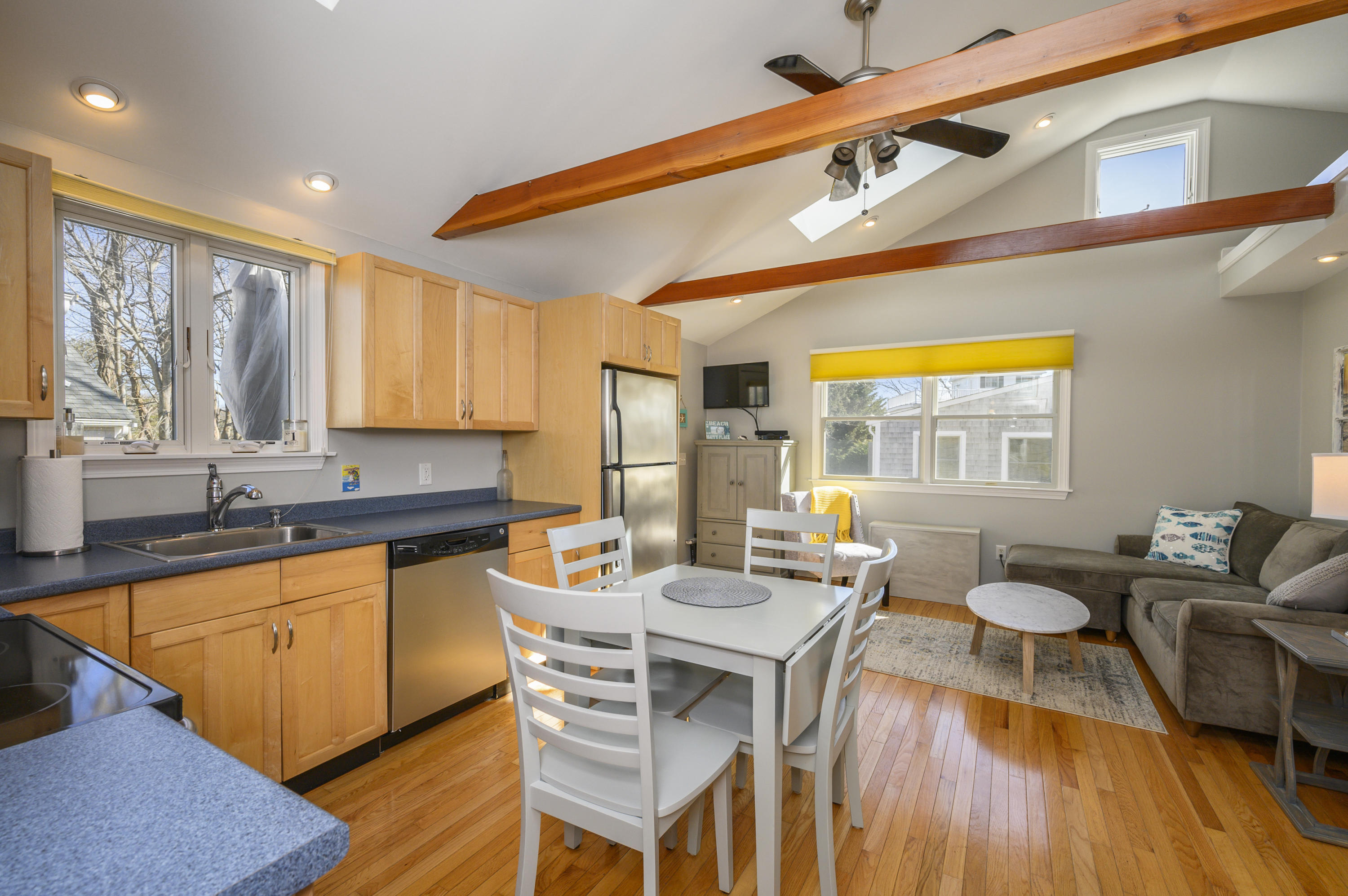 a dining hall with stainless steel appliances granite countertop a stove and a sink