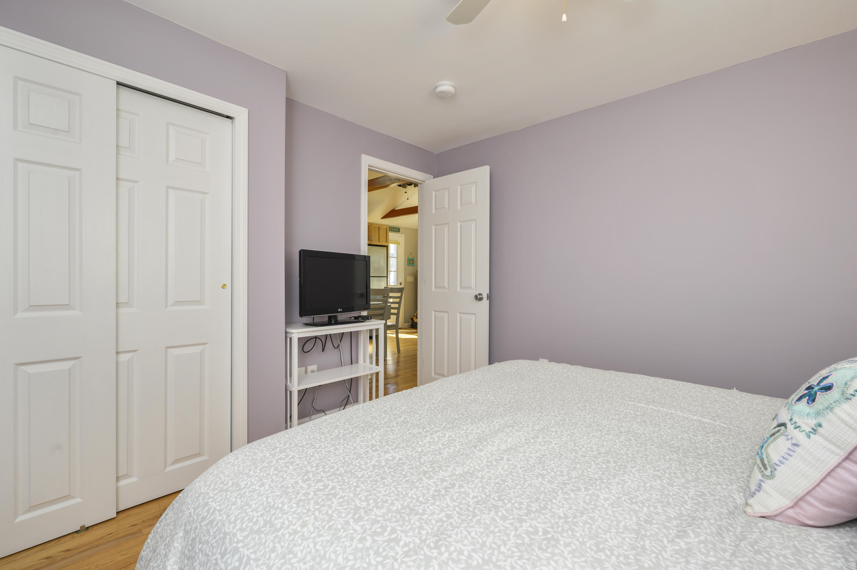 27 Locust Road, Unit 2 Eastham, MA 02642 - Photo 11 of 26 a bedroom with a bed and a flat screen tv