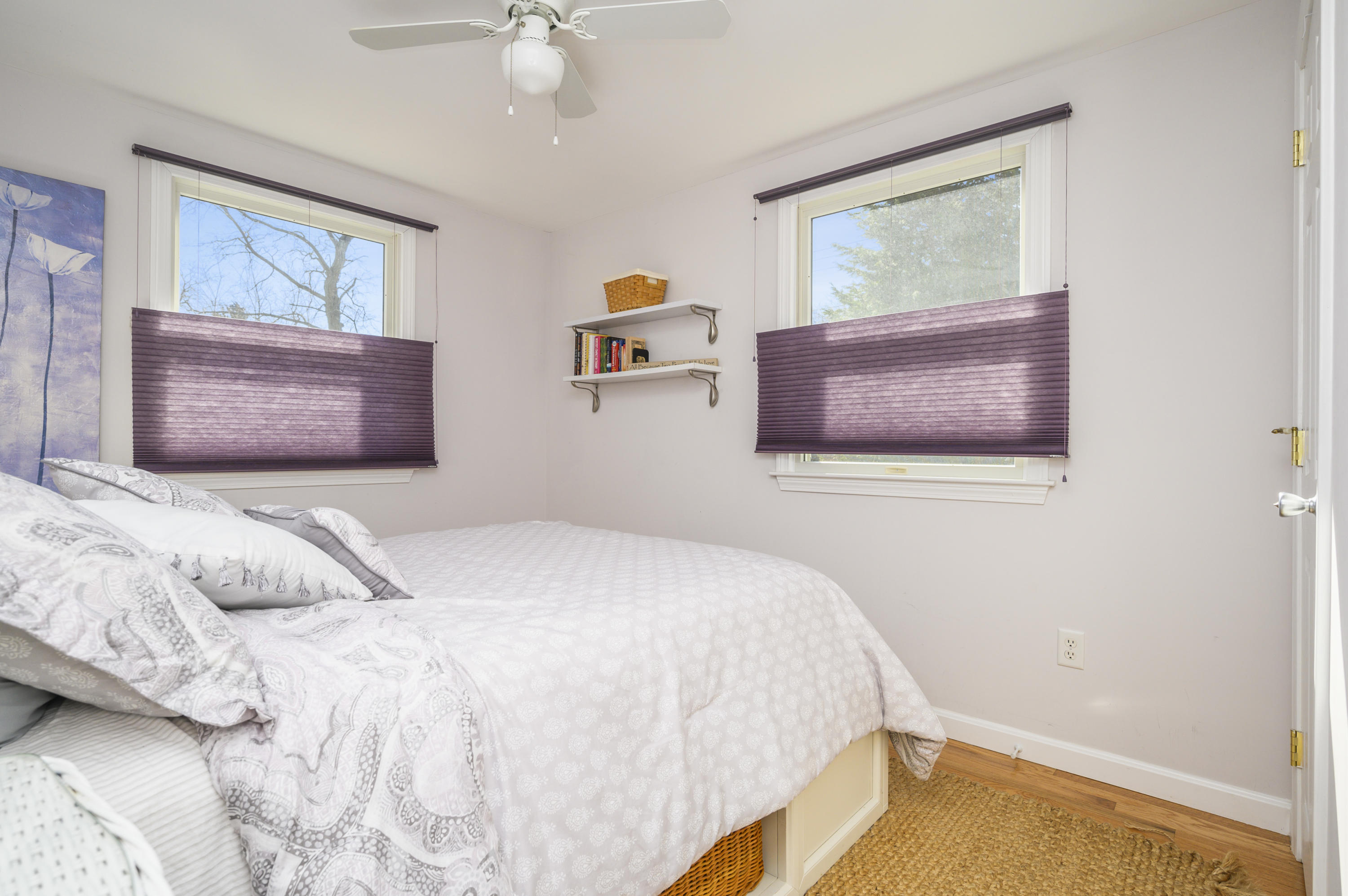 27 Locust Road, Unit 2 Eastham, MA 02642 - Photo 12 of 26 a bedroom with a bed and a painting on the wall