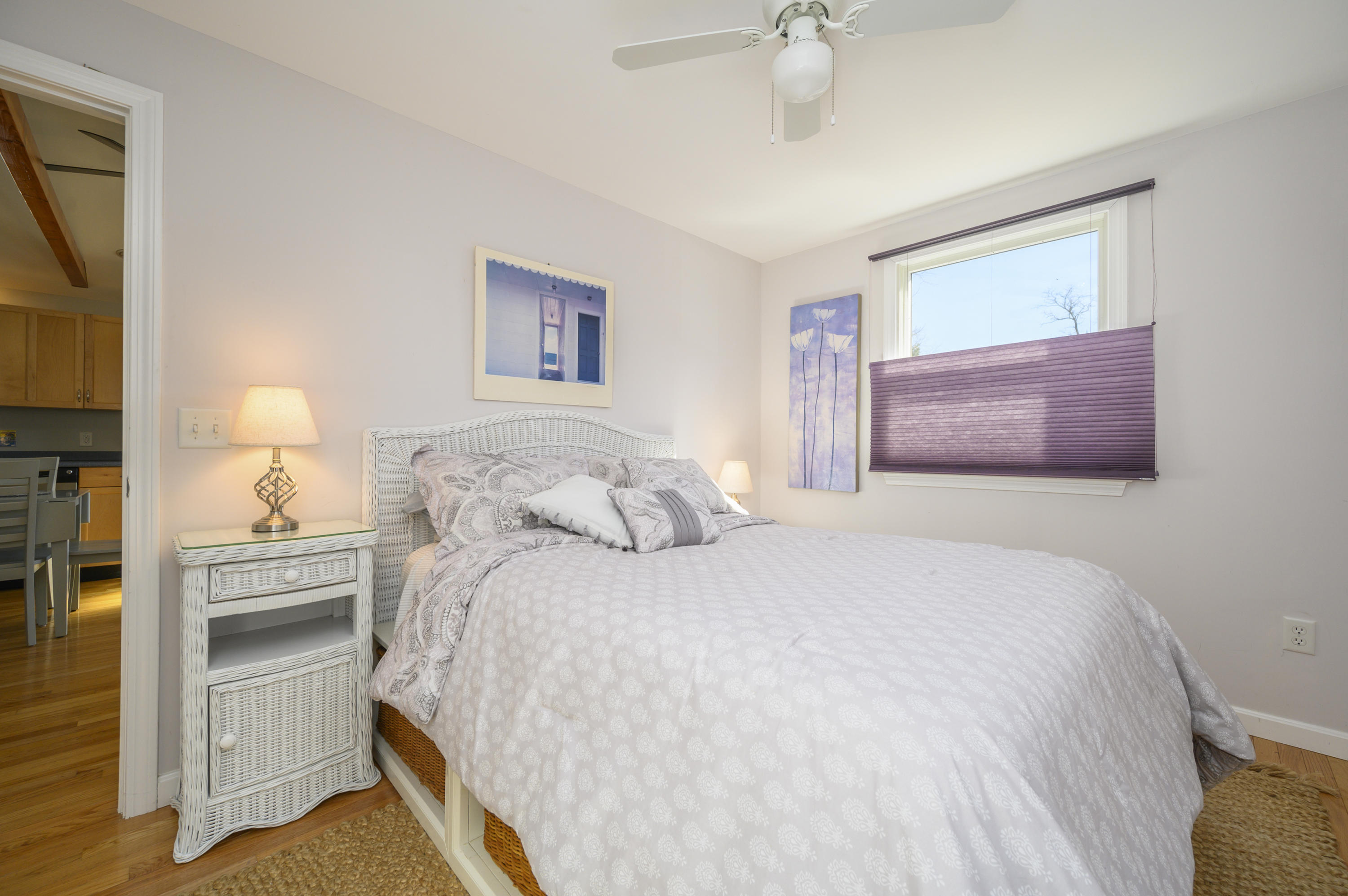 27 Locust Road, Unit 2 Eastham, MA 02642 - Photo 13 of 26 a bedroom with a bed and a chandelier