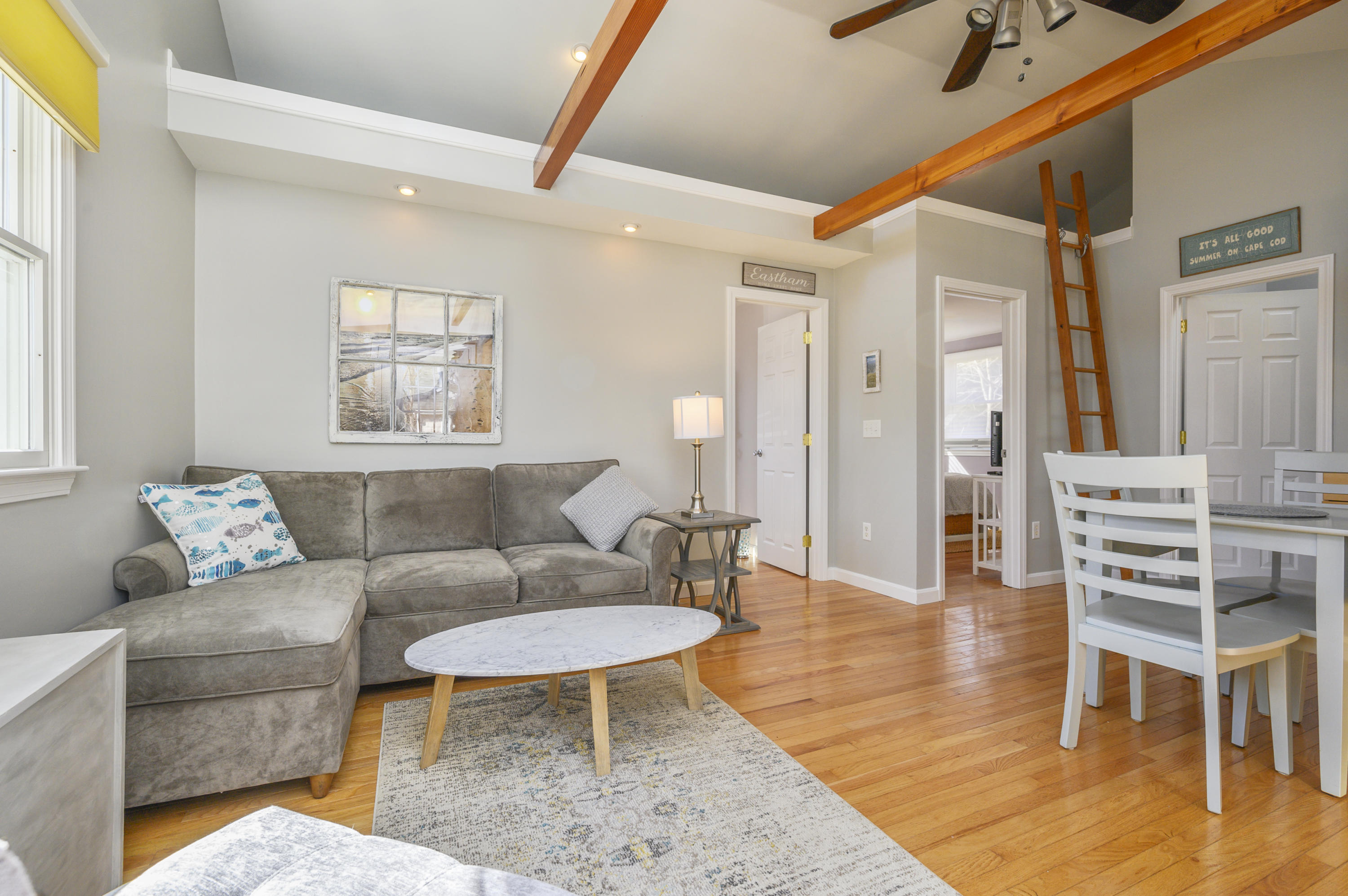 27 Locust Road, Unit 2 Eastham, MA 02642 - Photo 2 of 26 a living room with furniture a rug and a table